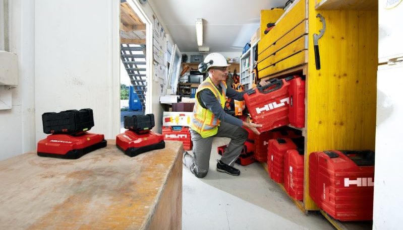 Tool Crib Manager putting away a Hilti Tool Box on a shelf in a construction container